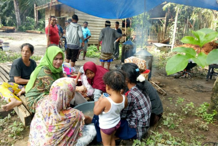 Anggota DPRD Rohul, Hj Hasmeri Yulinawati atau Memey (Jilbab Hijau) tengah memasak bersama warga terkena banjir